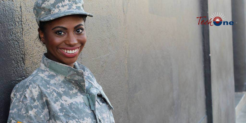 phone, fintech notebook, and coffee cup on table, with a hand over the notebook with a pen.