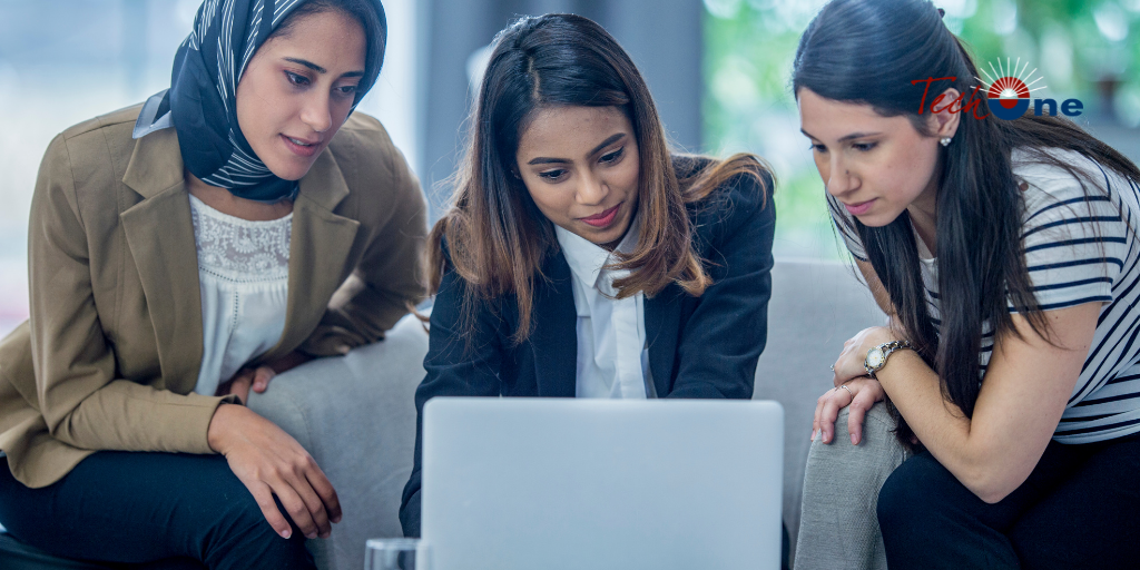 phone, fintech notebook, and coffee cup on table, with a hand over the notebook with a pen.