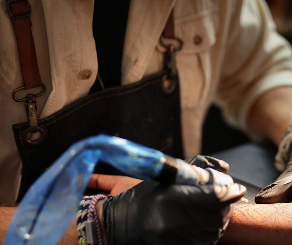 phone, fintech notebook, and coffee cup on table, with a hand over the notebook with a pen.