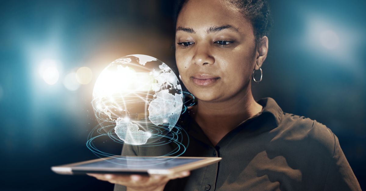 phone, fintech notebook, and coffee cup on table, with a hand over the notebook with a pen.